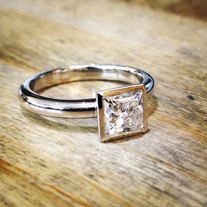 Princess cut rub over solitaire 18ct white gold engagement ring